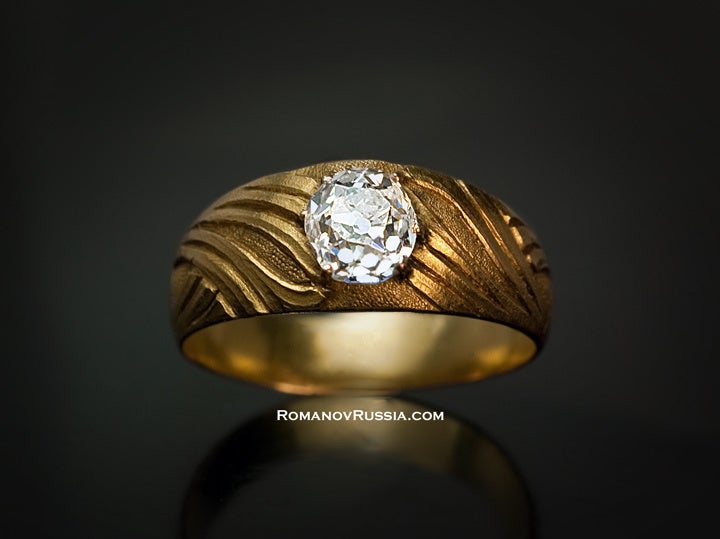 The matte yellow gold ring is decorated with interlaced stylized foliage in Art Nouveau taste.


56 zolotniks (14K - 583 gold), one old mine cut bright white diamond of an excellent color (D-E), approximate weight 1.25 ct, clarity VS2

The ring
