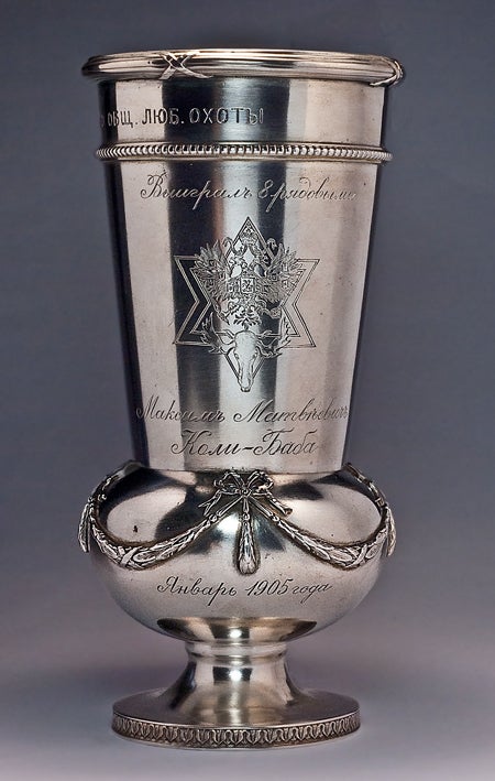 The trophy was made by Faberge's Moscow branch between 1899 and 1905. It is fully marked under the base with Moscow assay stamp of the period, Faberge name, and original Faberge's scratched inventory number.
The silver trophy is decorated in