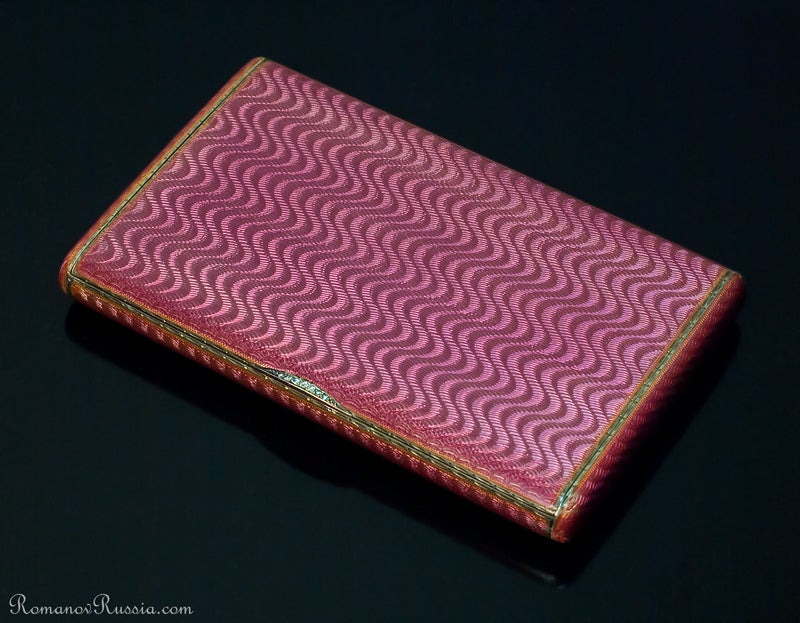 Russian Imperial era ladies' cigarette or card case, made in St. Petersburg between 1908 and 1917, by the 3rd Jewelers' Artel.

The gilded silver case is engine turned with a wave moire pattern and covered with a very beautiful purplish pink