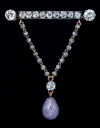 A very stylish and unique antique diamond brooch / pin with guilloche enamel egg charm.

Unmarked, attributed to Peter Carl Faberge.

A beautiful lavender purple guilloche enamel egg with a silver luster, hanging on a rose diamond encrusted