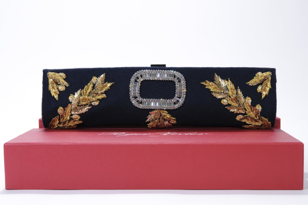Classic Black Felt with beautiful gold-thread embroidery and sequins, with the most iconic giant crystal Baquette Rounded-Edge square (works almost like a logo) in the middle. 
Comes in its white satin dust bag and ubiquitous red box, a serial