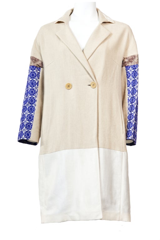 This bohemian aesthetic patchwork cotton blend coat is made of textured beige cotton contrasts with the violet jacquard sleeves.  Button fastening through front with side-seam pockets. Fully lined.