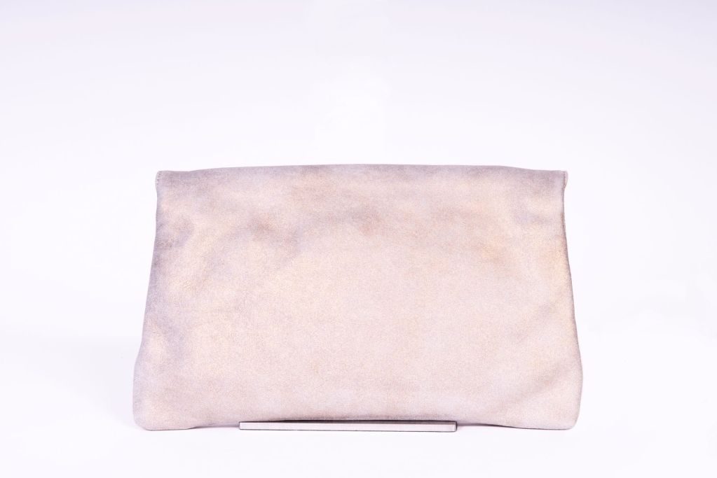 This Balenciaga gold beige envelope clutch is a limited edition and made of soft vintage lambskin.  One exterior zipper pocket on the flap front.  Closes with a snap closure.  This clutch is very roomy wtih a few compartments.  Comes with a leather