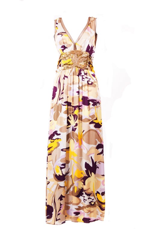 This colorful Missoni floral printed silk dress is an excellent choice for evening.  It features with a deep V neck and embellished waist with a tie that enhance and streamline anyone's silhouette.  Key hold fastening at back. Fully lined.