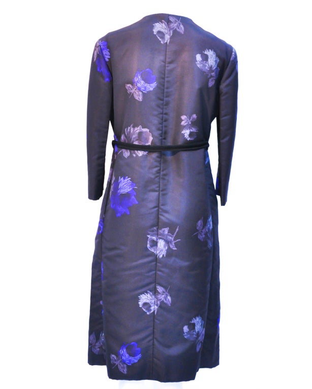 An exquisite Asian inspired Prada multi-colored floral print midcalf length silk coat with beautiful embroidery details.  Concealed snap fastenings through front with a black grosgrain belt.