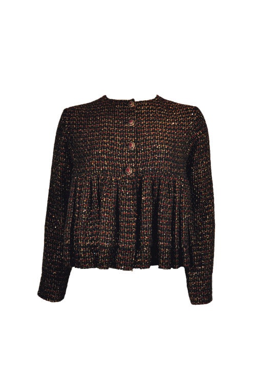 This round neck Chanel lesage tweed cropped top was inspired by jewels and fabrics of India.  It's a combination of the brand's iconic French chic, style and opulent India luxury. The tweed is in burgundy, black and matte gold with gold sequins