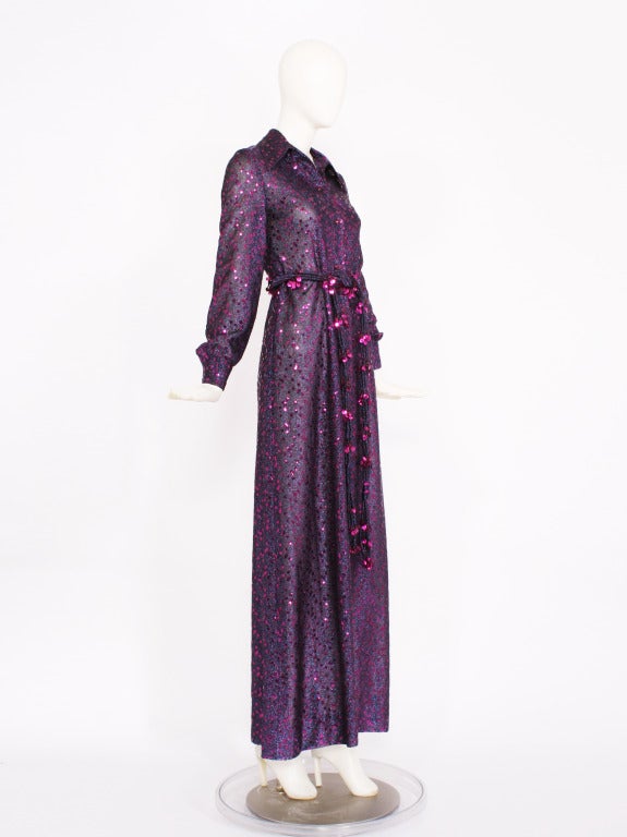 This is a stunning numbered dress by DIOR. Long sleeves that button at the cuff and button front. A long belt with tassels at the end. Metallic thread glistens and fuchsia sequins embellish the entire dress and belt. A stunning creation. Mint