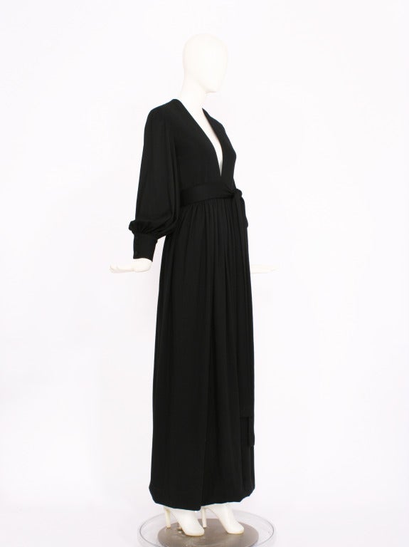 NORELL-TASSELL 1970s Black Blouson Sleeve Maxi Dress with a deep V cut in front of dress. Long sleeve and ties with an attached belt at side. Cashmere fabric. Excellent Condition.
Fits sm-med.

Store Location:

DEVORADO
436 E.9th St.
NYC, NY
