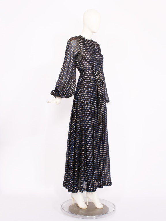 Yves Saint Laurent Haute Couture Dress #29191 from the 1970s. Classic 1970s maxi dress. Gorgeous black chiffon fabric embellished with blue and gold metallic thread.  Blouson sleeves and belt. Exquisitely crafted and in excellent condition. Fits