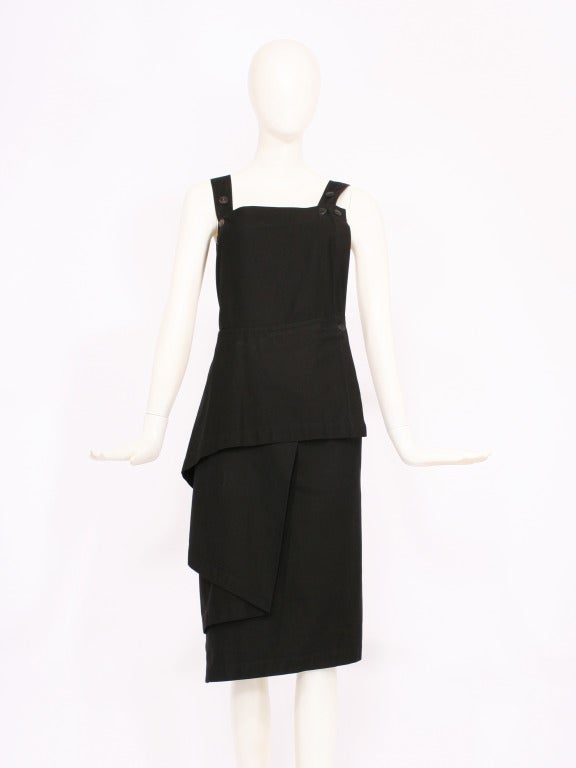 Yohji Yamamoto black avant-garde pinafore dress. Cut out , partially exposed back.. Buttons to adjust the waist and shoulder straps. Pocket on hip. Asymmetical cut on bottom. 100% cotton.
Excellent condition. Fits s-m and is adjustable.  

Store