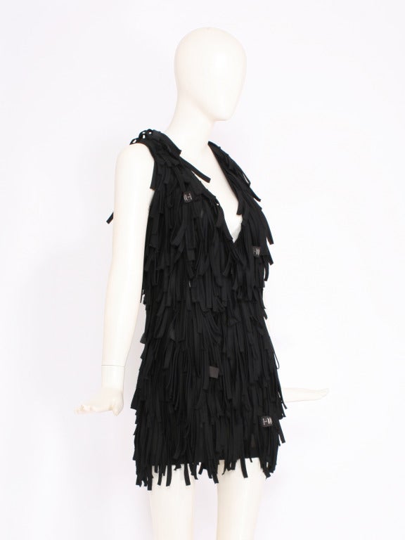 Black fringe dress by cult status Japanese designer UNDERCOVER. Deep V cut with fringe style material and exterior labels attached. Mini dress length. Mint Condition.
Fits small-medium sizes.

Store Location:

DEVORADO
436 E.9th St.
NYC, NY