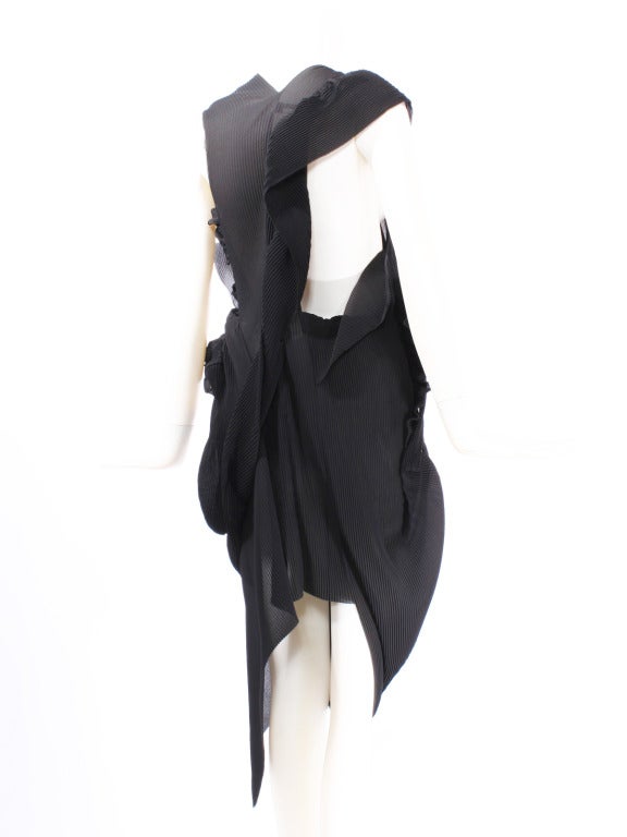 Comme des Garcons by Junya Watanabe Open Back Black Avant Garde Dress. This is a spectacular dress that wraps pleated swaths of fabric around the body. Assymetrical silhouette. Fits sizes from small to large due to versatile design.  A true work of
