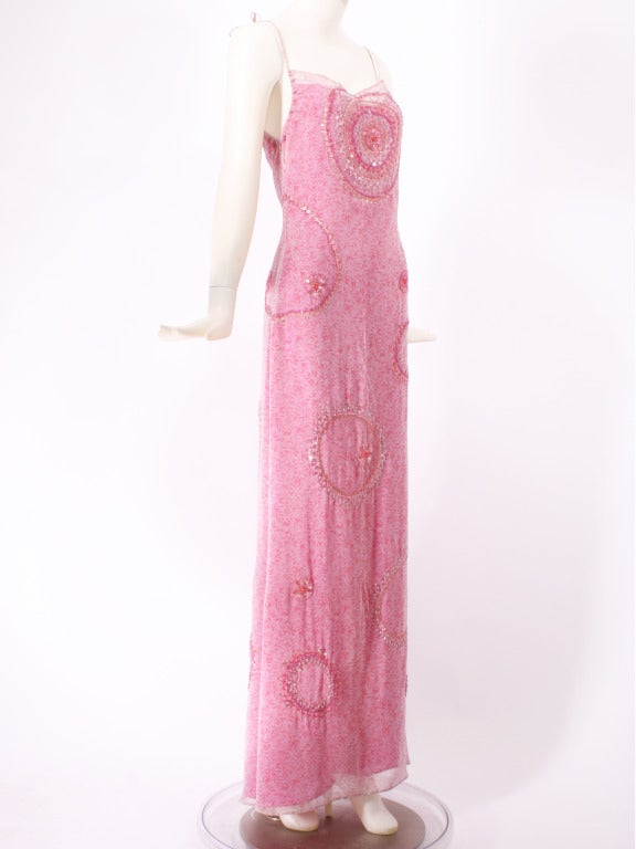 Badgley Mischka Pink Beaded and Sequins Gown. Master craftsmanship is displayed throughout this gown. Beautiful gossamer layers of silk chiffon are is embellished with varying hues of pink beads and sequins. Shoulder straps are adjustable. In new