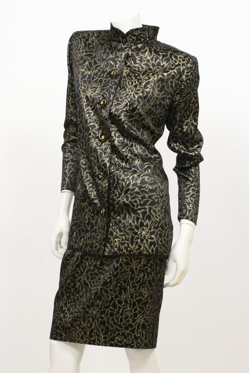 Haute couture ensemble created by the maison of Yves Saint Laurent.  A very elegant piece, it is numbered 58581 and was created c.1985. The set consists of a pencil skirt and mandarin collar top. The material is extremely soft painted silk.

Store