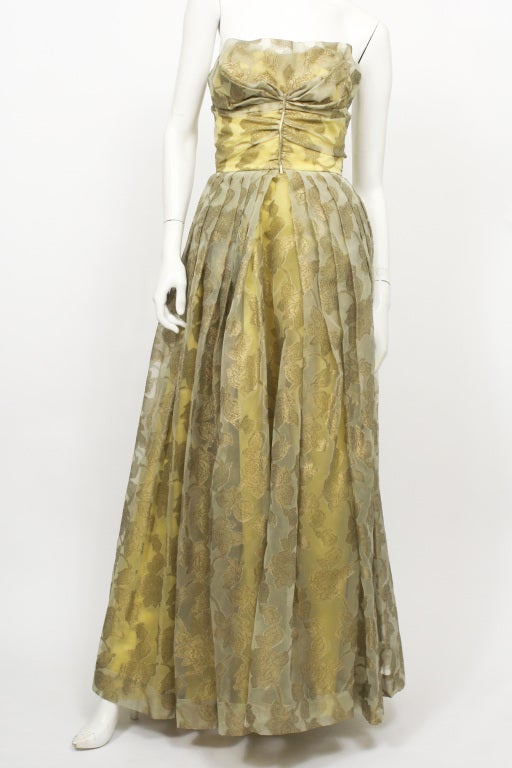 Helen Rose gold floral strapless gown.  Floor length. Pleated skirt. Gathered bodice. Empire waist. Zips up the back.  Excellent condition.

Helen Rose was the creator of Princess Grace Kelly's wedding dress.

Store Location:

DEVORADO
436