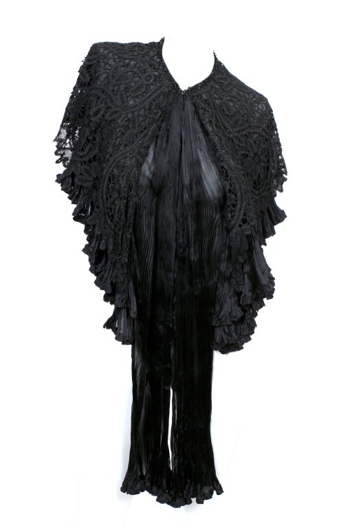 Exquisite Victorian Cape made from silk, lace and jet beading.  The cape had two layers of silk accordion pleating under the lace that converge in the front in the form of a long wrap. The collar has jet beading detail. Excellent condition- one of