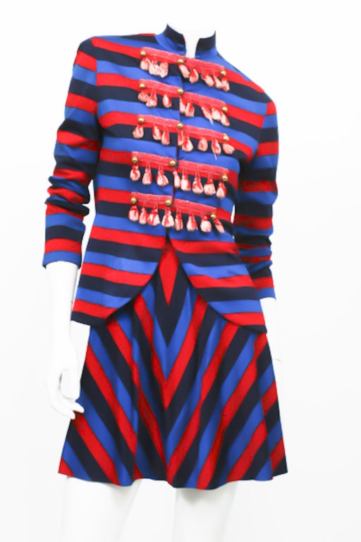 Michael Mott for Paraphernalia SGT. Pepper Dress. Highly collectible and extremely rare. Navy blue, royal blue, and red striped pattern. Tassel embellishment detailing on jacket. Thigh-length skirt. Jacket buttons up the front. Excellent