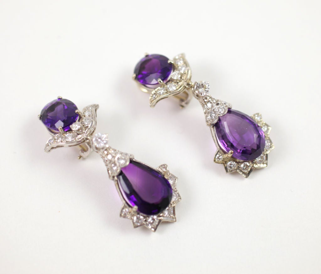 A pair of  white gold, platinum and diamond earrings set with rich royal purple amethysts and bright white diamonds. They were a product of the 1960's and originate, in all probability, from the USA. Comfortable  clips that stay in place keep the