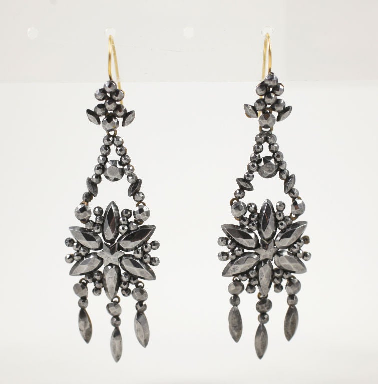 The wonders of the nature are the flowers of the earth and the stars above. Both are to be seen in this pair of cut steel Georgian earrings. The steel bits vary in size and shape, always the signal to the quality of workmanship and the age of this