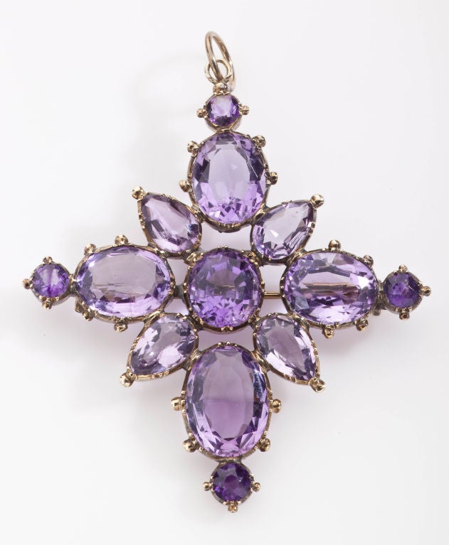 A color found only in nature and put in a beautiful form makes this pendant a rare treat.  The  brilliance and purity of amethysts and the beautiful gold setting are a standout. Early Victorian, this Pendant/Brooch is to be worn suspended from a
