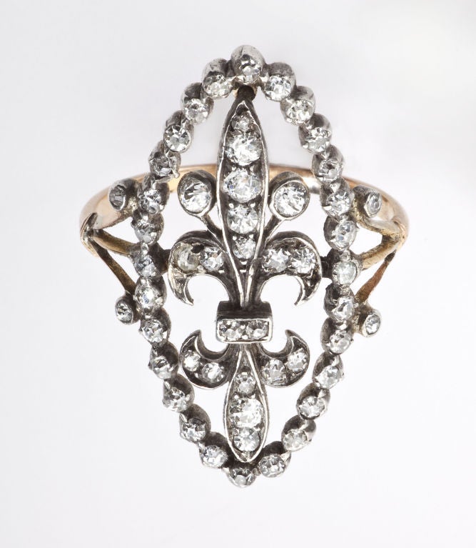 This ring deserves attention and gets it for its unique grace, size and shape.  A mix of fifty-two Old Mine and Rose Diamonds form a  navette that frames a double Fleur Dis Lis. Although an English jewel,  one cannot help but think of French