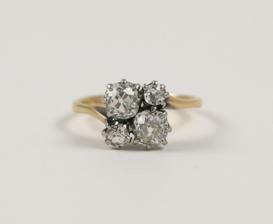 Four old mine diamonds sit in opposition to each other in our engagement ring from the turn of the 20th century, the Edwardian period in Great Britain. The larger diamonds are approximately a half carat each. The smaller are approximately .25 each.