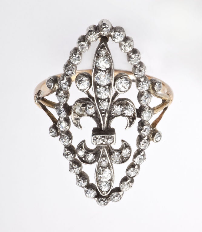 This ring deserves attention and gets it for its unique grace, size and shape. A mix of fifty-two Old Mine and Rose Diamonds form a navette that frames a double Fleur Dis Lis. Although an English jewel, one cannot help but think of French