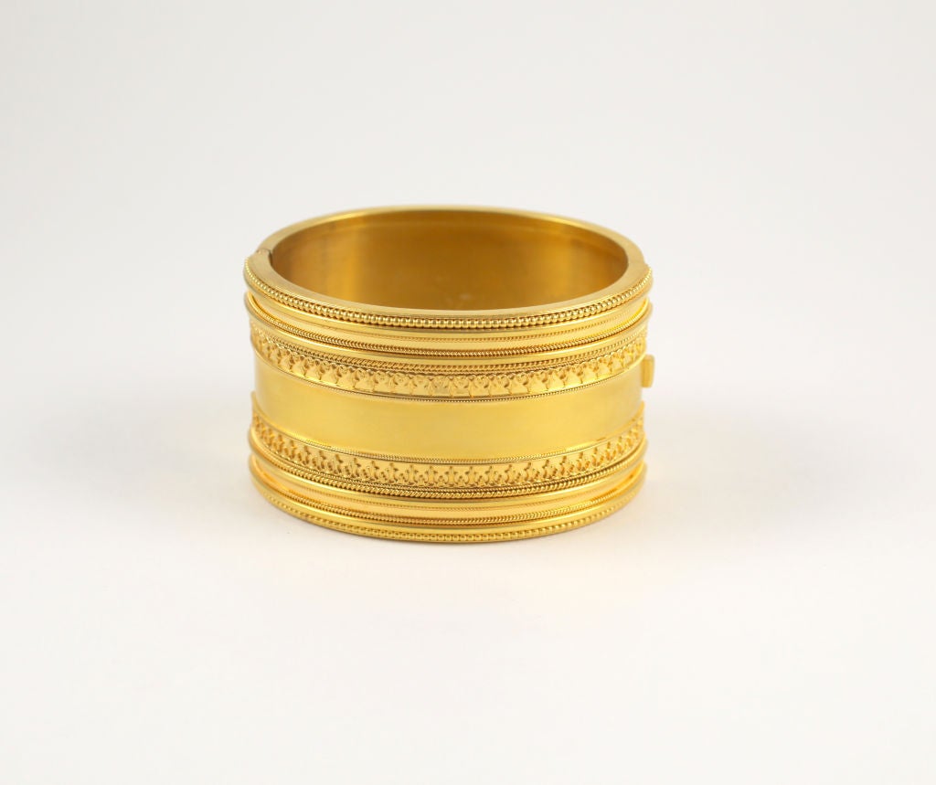It is a challenge to take your eyes off this cuff. The satin surface is striking. It is Victorian Etruscan Revival in pristine condition.  At front, the surface is raised by eight lines of beaded and coiled rope, separated by a contrasting half inch
