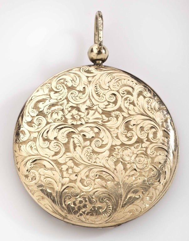 Large and proud of it, this  English, late 19th century locket is engraved on both sides and bears a symbolic family crest in the center. Symbols like this are lost in history and become puzzles today. At times we can come close to deciphering the