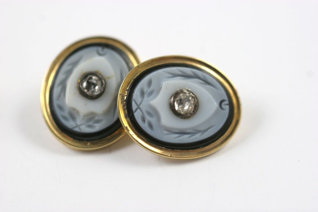 These are cuff links for a person of distinction. Fidelity is symbolized by the sprays of rosemary carved into this pair of Victorian banded agate double cufflinks. Oval golden frames hold miniature detailed carvings raised from the white bands of a