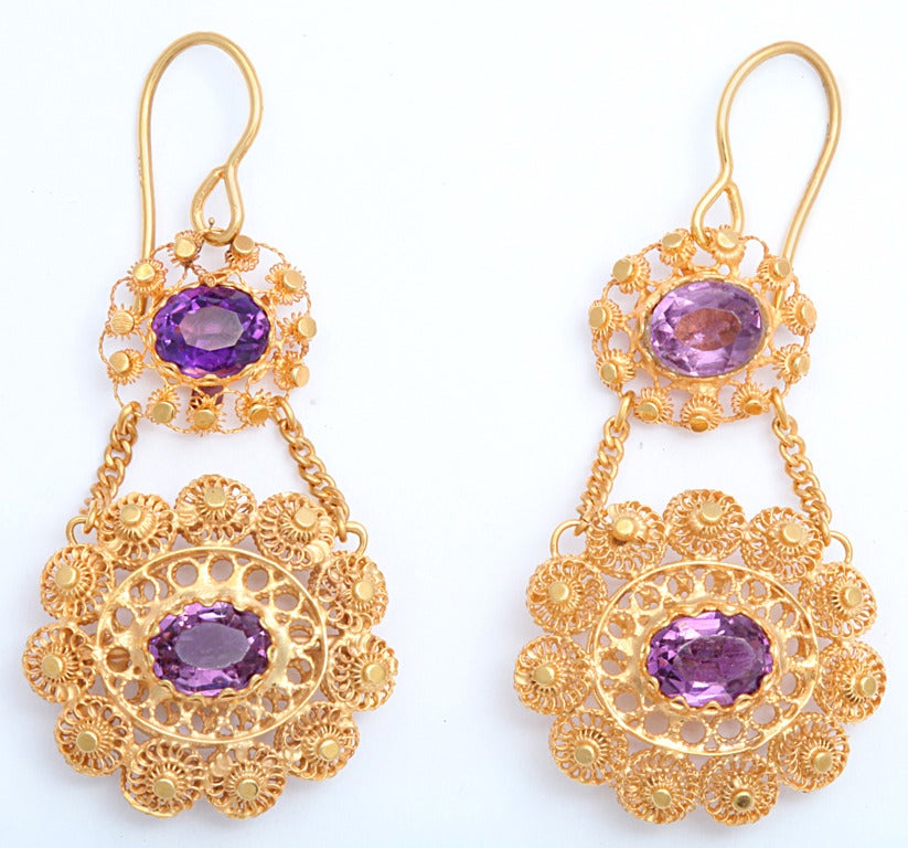 The special characteristic of these Georgian earrings is that they are double sided. Twice the amount of gold and gemstone was used and twice the work was done. They are also in perfect condition.  Around the discs is a variation of cannetille work