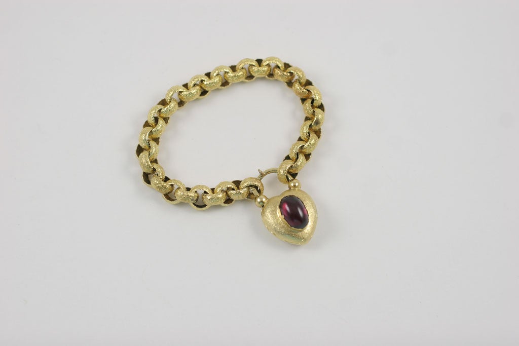 The sentiment that arrives with a Georgian or Victorian heart padlock bracelet is easily understood. It is a design that led to but far preceded the charm bracelet of the mid 20th century. Worked in 18kt gold, the round links connect in alternating