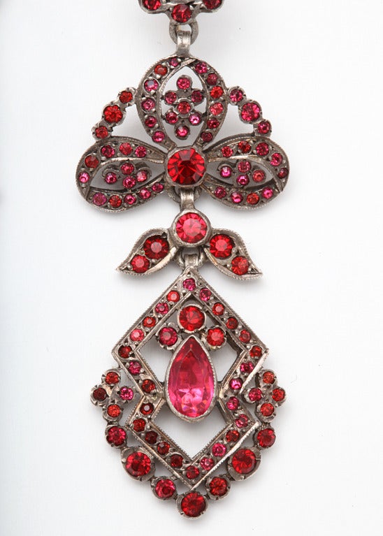 Superb quality earrings designed with the flourish of garlands, have been made of foiled pastes in the manner of Georgian and Victorian earrings. The brilliant pastes are the rare pink color that flatters all women. Paste this fine was an art form.