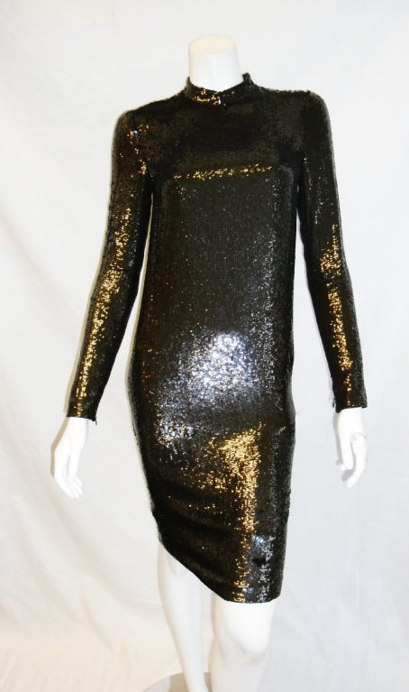 Fish-scale micro sequin on silk chiffon . Long sleeves. Mandarin collar. Concealed back zipper. Dark brown color. Zippered sleeves for perfect fit. Silk lined.
New without tags. Never worn. Size 4
Measurement are:
Bust: 34