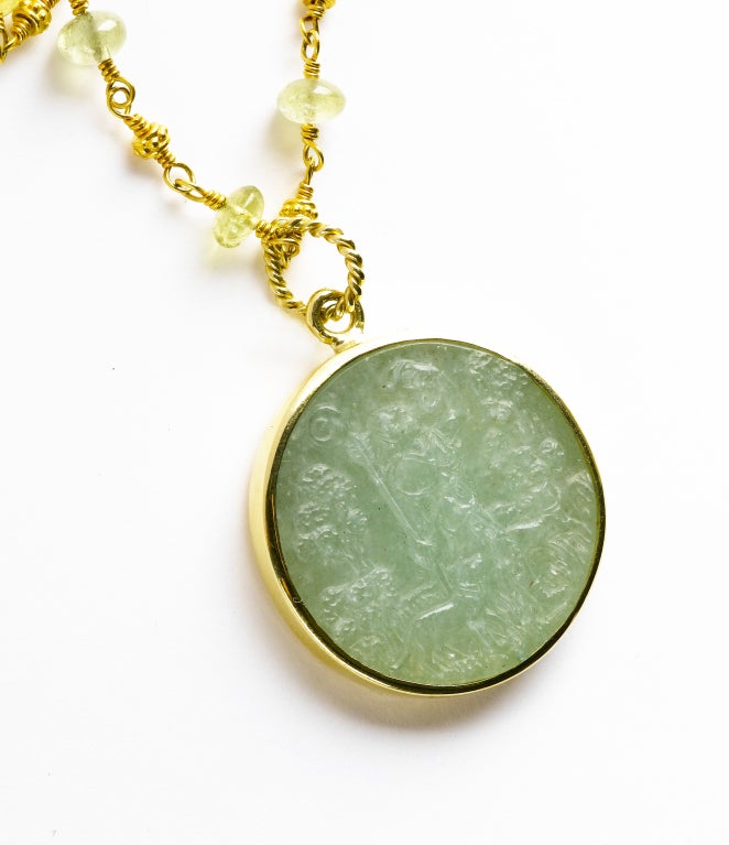 Hand carved aventurine replica Italian medal from the 16th century with the female figure of Ippolito (who is seen as the huntress & loved for her piety & accomplishments). Set in an 18K gold surround and twist wire loop.  The accompanying beaded