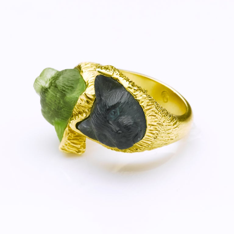 Unique double headed green and blue tourmaline hand carved cat head ring set in heavy gold band. 12x12x8mm stone sizes. Ring size 7