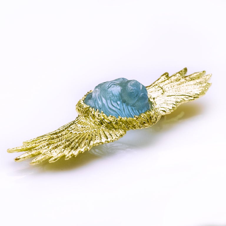 This is truely a unique piece to pass down through the generations! Beautifully hand crafted aquamarine lion head pin in an exquisite gold winged design setting.