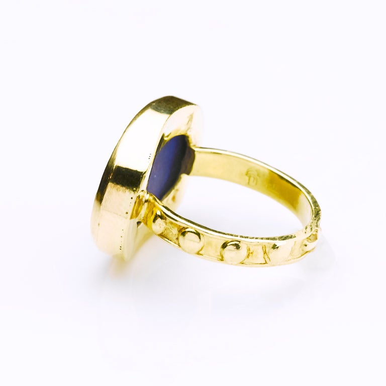 Hand carved lapis lazuli chariot ring engraved with gold inlay and 18 karat gold prayer band. 15x20mm lapis size. Ring size 8 1/2.