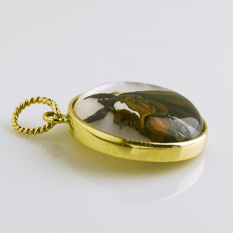 Exquisitely painted horse head quartz crystal pendant backed with Mother-of-pearl set in18karat gold frame with gold twist wire bail. 25mm round.

A portion of the proceeds will be dedicated to the Boston Park Rangers.