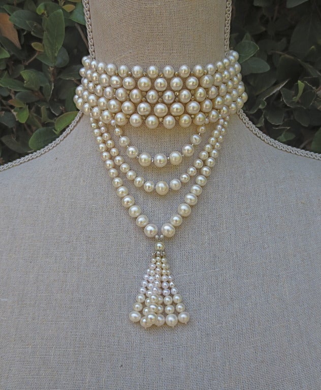 This stylish choker features 5 - 7 mm pearls beautifully woven with faceted sterling silver beads and is finished with elegant graduated pearl drapes and graduated pearl tassel.  This choker would look perfect on a tall and slender neckline and is