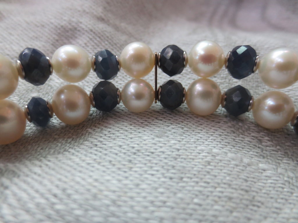 The bracelet's floral clasp also serves as it's centerpiece. Bracelet is made of  6.5 - 7mm cultured pearls, rough faceted sapphire beads and 14 white gold findings and clasp. The bracelet is very versatile and can be worn dressed up or down.