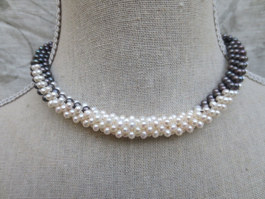 White pearl, black pearl and onyx are woven together to create a rope style necklace with colors graduating from dark to light. Woven round, not twisted strands. Beads measure 3.5mm each, and woven into a thick tubular rope of approximately 1/3 of