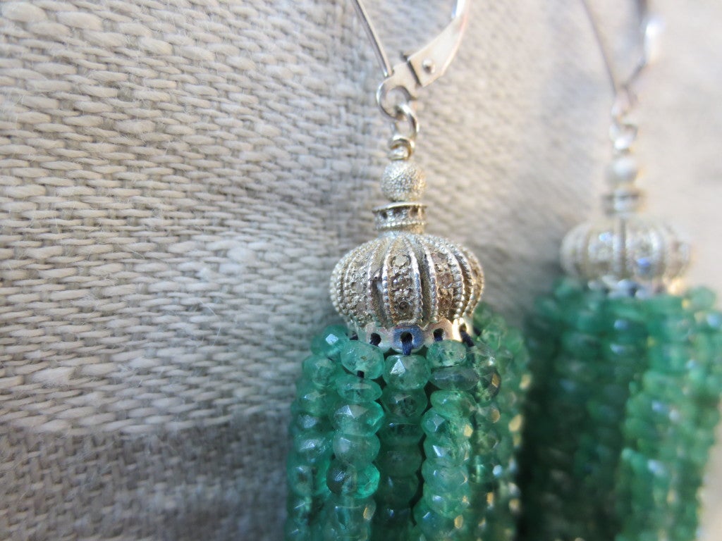 These tassel earrings are made of tiny faceted emerald and sapphire beads measuring approximately 1.5mm each. The tassels hang from a diamond encrusted white gold cup. Earwires are made of white gold. Suprising light, these earrings are not heavy