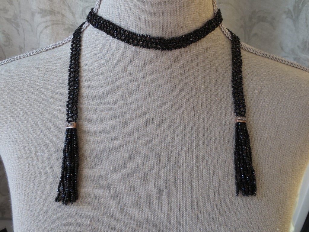 Gorgeous and stunning sautoir is hand woven with faceted onyx beads that beautifully catch light. Shimmering and sophisticated, this sautoir is reminiscent of the 1920s. Necklace is hand woven with 1 mm faceted onyx beads into a delicate lace-like