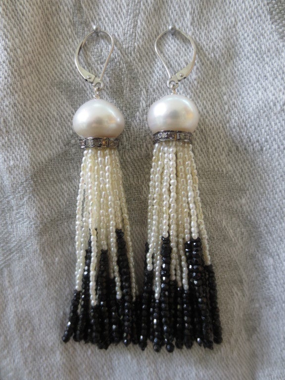 These elegant black and white earrings are timeless. The tassels are made of tiny seed pearls and onyx. The faceted and graduated onyx beads on the bottom of the strands catch light beautifully, giving the earrings a brightness and ethereal quality.