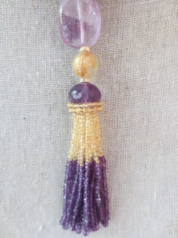 This luxurious citrine and amethyst beaded necklace with 14 K yellow gold magnetic clasp is handcrafted by Marina J. The citrine, amethyst and 14 k yellow gold beads are composed to highlight the colors of the stones. The 2.6 inch tassel starts with