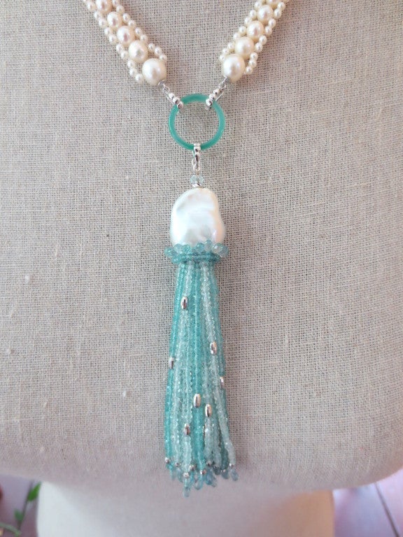 Stunning and stylish sautoir is extremely versatile. Gorgeous tassel is made of aquamarine and blue topaz faceted beads accented with faceted silver beads. Each strand tapers at the end with small aquamarine briolettes. Tassel cap is made of a large