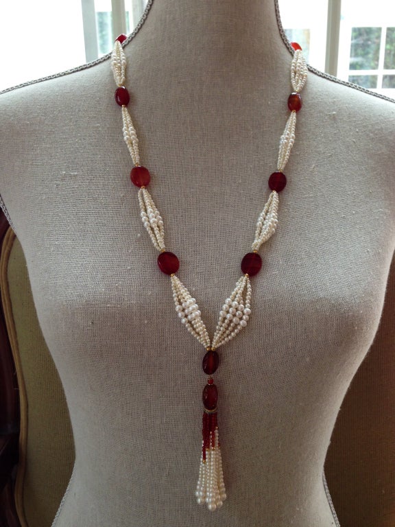 This elegant sautoir features slightly graduated pearl clusters between luxurious old carnelian beads.  Faceted 14K yellow gold beads. Tassel features carnelian, a 14K gold and diamond rondelle, slightly graduated pearls, carnelian beads, and
