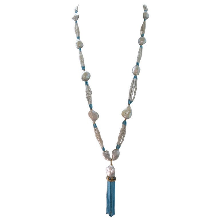 This vibrant sautoir is composed of beautiful large hand selected baroque freshwater pearls sectioned off by delicate and slightly graduated strands of pearl and turquoise beads.  The tassel is created using a large baroque pearl, custom 14k yellow