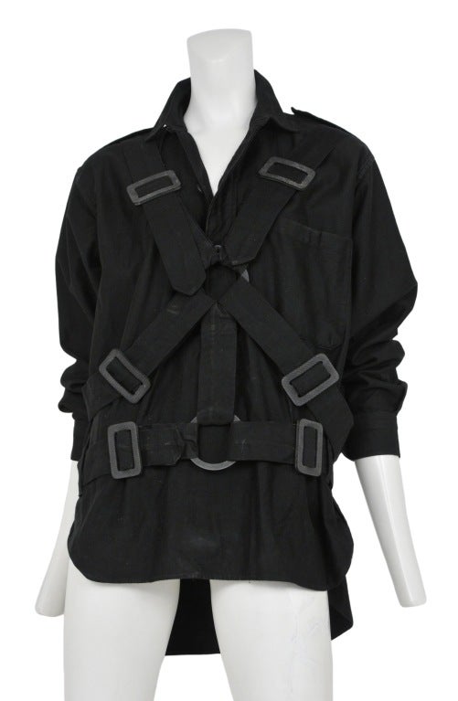 Black twill flight bondage jacket with adjustable straps at back and chest.                    c. 1976
